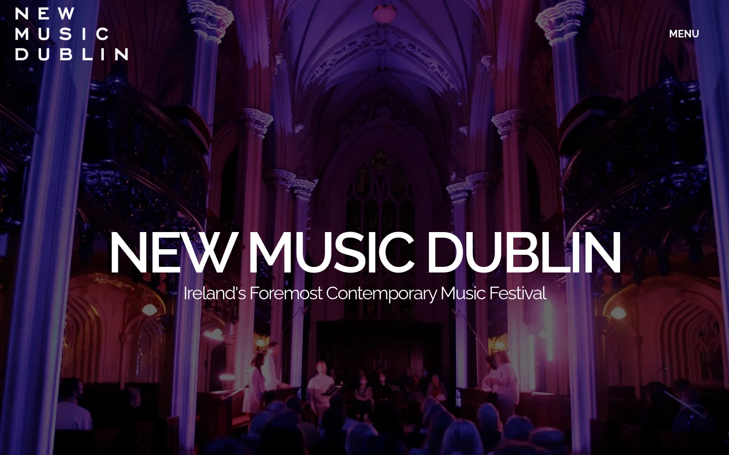 The desktop homepage features a full-width hero image of a concert inside a gothic church with dramatic purple and pink lighting. The 'New Music Dublin' logo is in the top left, a 'Menu' button is in the top right, and the main headline 'NEW MUSIC DUBLIN' is centered in large white text over the image.