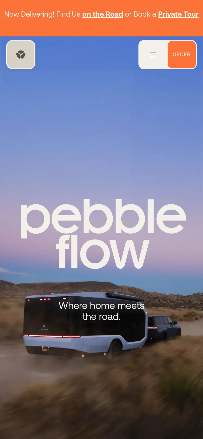 The mobile version presents a vertically stacked layout with a simplified header containing a logo on the left and a menu icon next to an orange 'Order' button on the right. The hero section features the large 'pebble flow' text overlaying an image of the RV trailer in a desert setting, followed by the tagline 'Where home meets the road.' below the text.