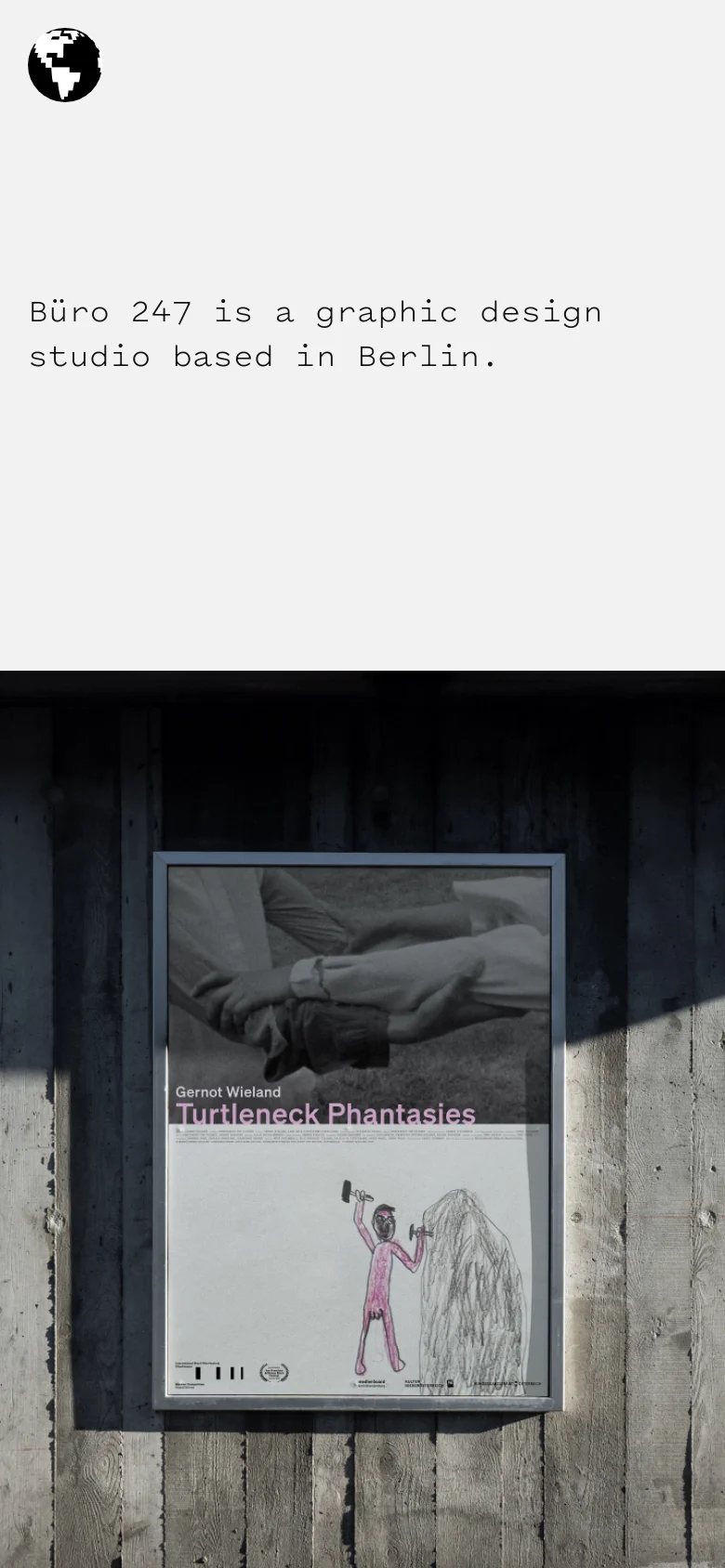 The mobile version maintains the minimalist aesthetic with a light grey background and black monospaced text. The layout is vertically stacked, placing the black globe icon and the studio description at the top, followed by a large, full-width image of a framed poster against a dark wooden background.