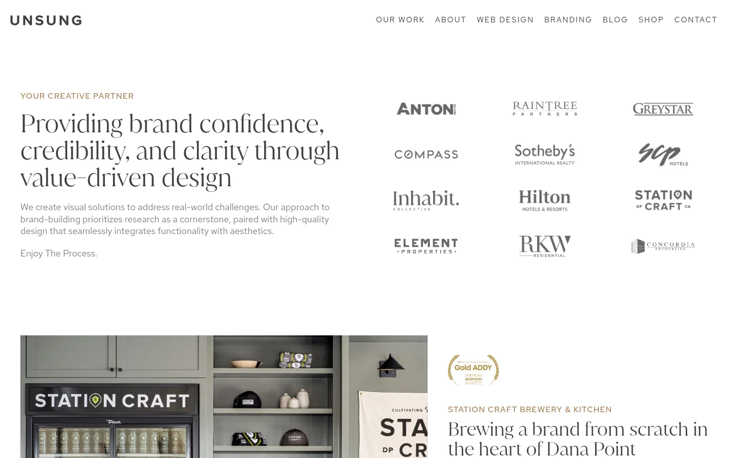 The desktop homepage features a clean, minimalist layout with a white background and dark serif typography. A hero section includes a large headline about brand confidence and a grid of client logos including Anton, Compass, and Hilton. Below, a featured project section shows a large image of Station Craft Brewery alongside descriptive text.
