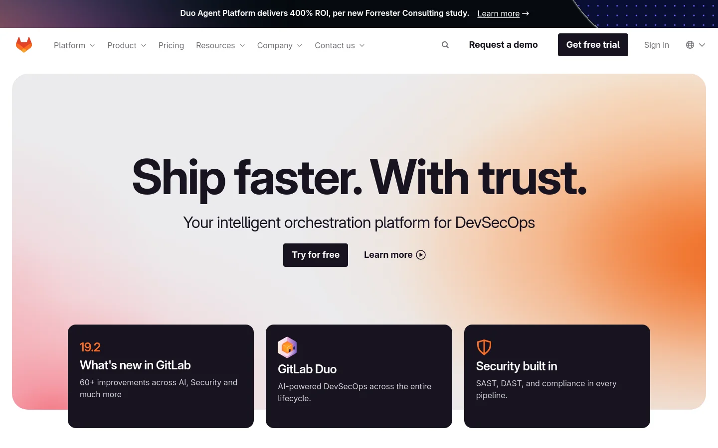 The GitLab homepage features a large hero section with a warm orange and pink gradient background and the headline 'Ship faster. With trust.' Primary calls to action include 'Try for free' and 'Learn more'. Below the hero, three dark cards highlight 'What's new in GitLab', 'GitLab Duo', and 'Security built in'.