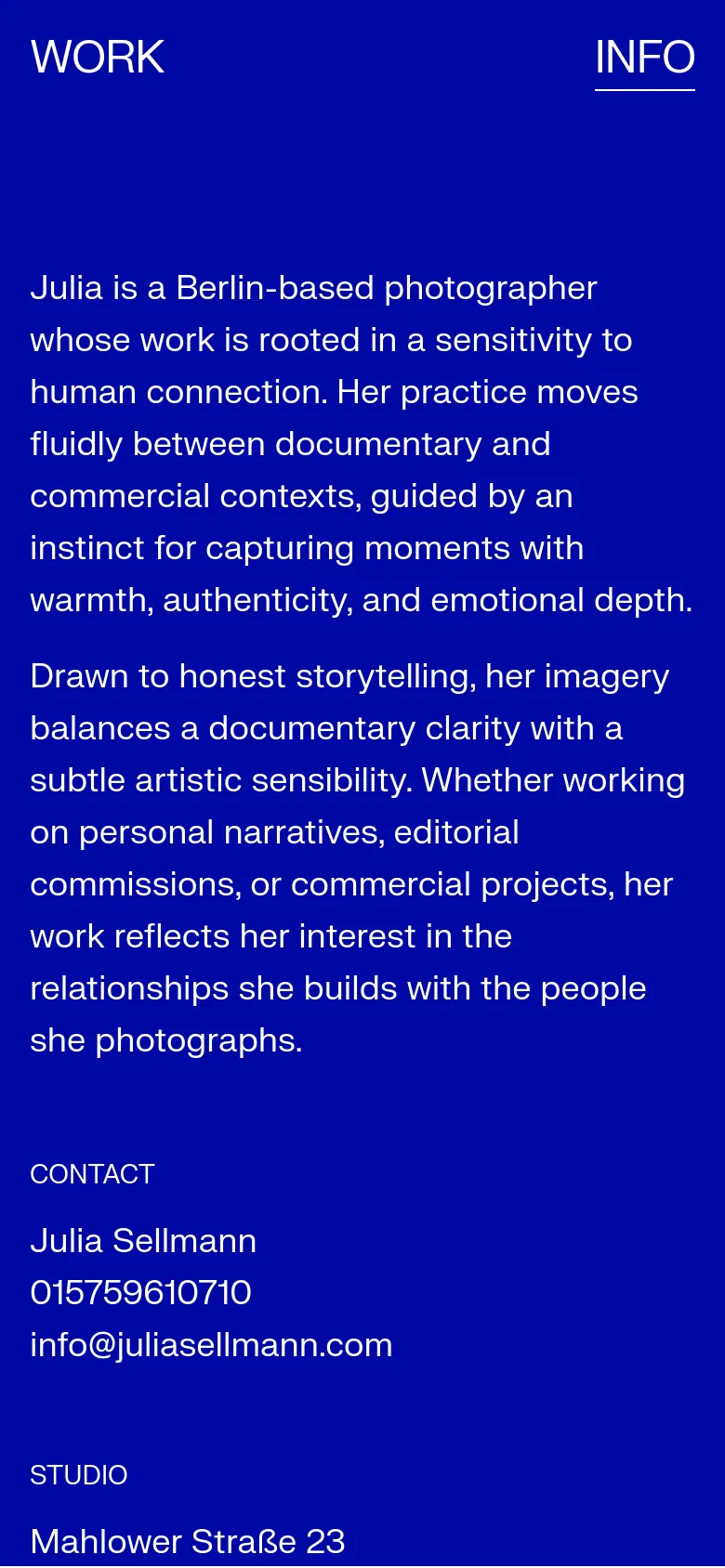 The mobile version maintains the deep blue background and white text but transitions to a single-column vertical layout. The large biographical text is positioned at the top, followed by contact, studio, and other information sections stacked vertically for easier scrolling.
