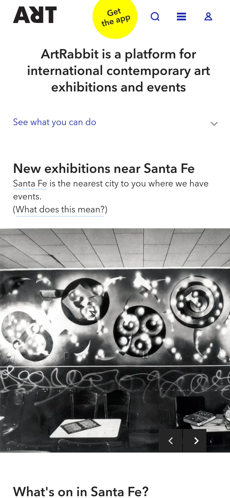 The mobile version presents a simplified, vertically stacked layout optimized for small screens. The header is condensed with a prominent yellow 'Get the app' button, and the hero image carousel occupies the full width of the screen. Navigation and content sections, such as 'New exhibitions near Santa Fe,' are arranged in a single column for easy scrolling.
