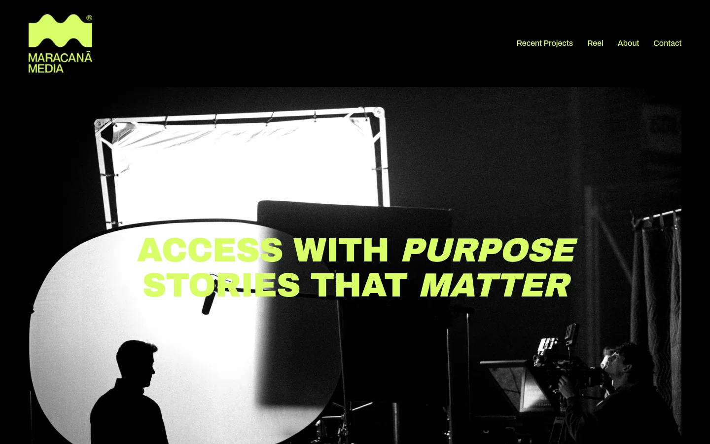 The desktop homepage features a black background with a lime green logo in the top left and a navigation menu on the right. A large, black-and-white hero image shows a film set with lighting equipment and silhouettes of crew members, overlaid with the bold lime green headline 'ACCESS WITH PURPOSE STORIES THAT MATTER'.