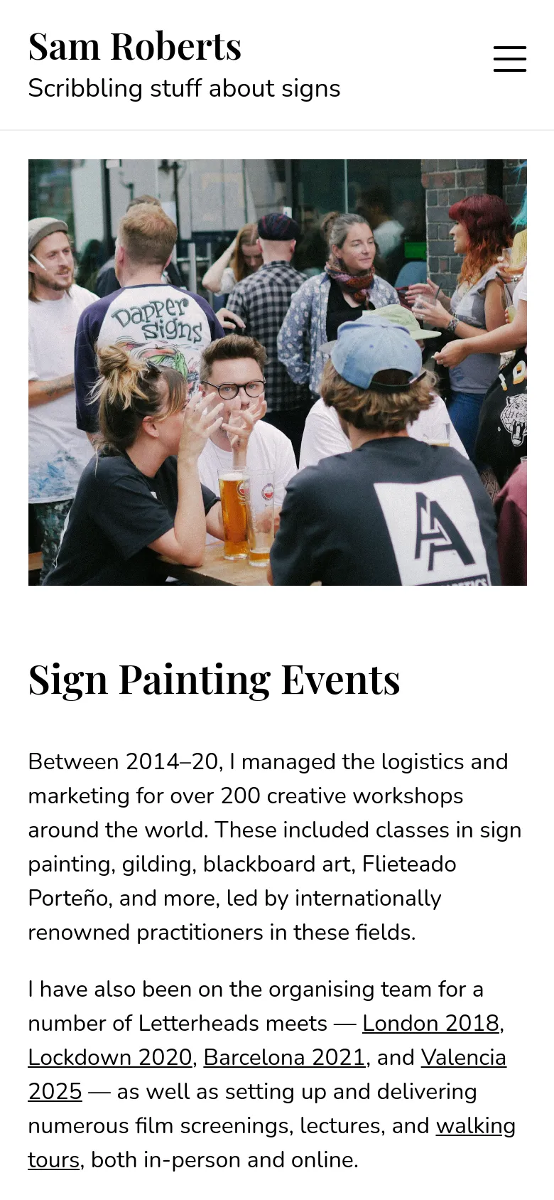 The mobile version displays a single-column layout with a large hero image of people at a workshop at the top. Below the image, the 'Sign Painting Events' headline and text content are stacked vertically. A hamburger menu icon is visible in the top right corner for navigation.