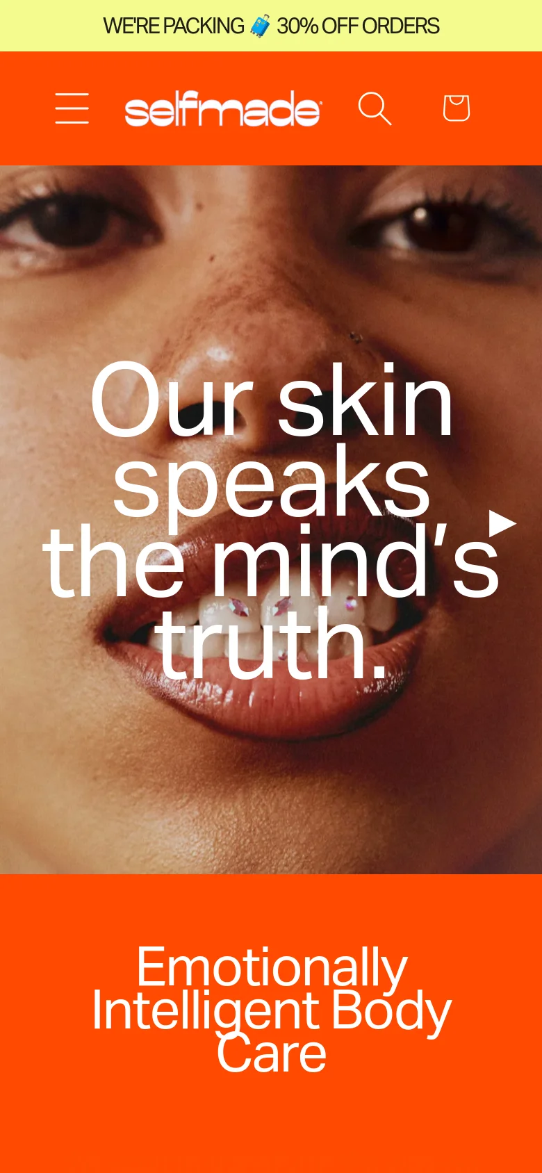 The mobile version uses a condensed orange header with a hamburger menu, logo, search, and shopping bag icons. The hero section displays a tight close-up of a person's face with the large white text, 'Our skin speaks the mind's truth,' stacked vertically to fit the narrow screen width.