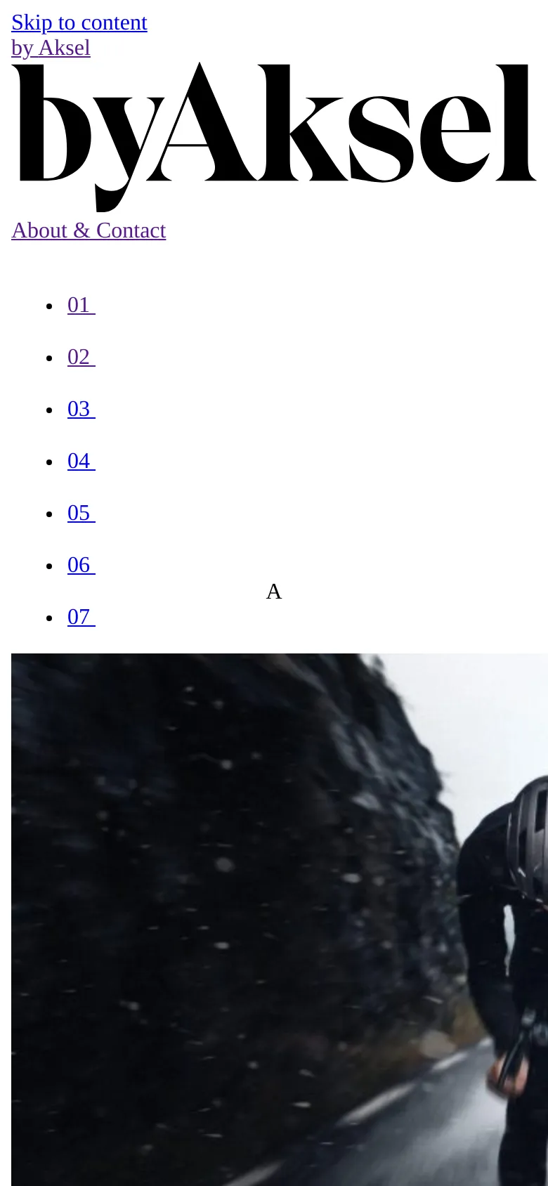 The mobile version maintains the large black serif logo and white background but rearranges the navigation into a vertical list. The hero image is cropped to a tighter, vertical aspect ratio, focusing on the cyclist against the snowy mountain terrain.