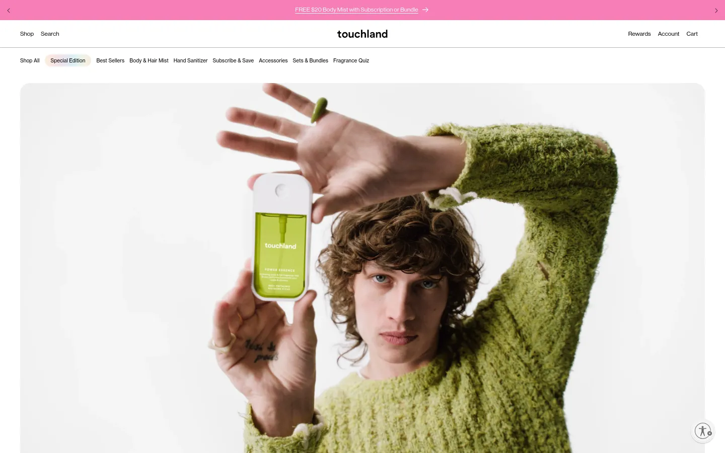 The desktop version features a large hero image of a person in a green sweater holding a lime-colored Touchland product against a white background. Below, the 'Welcome to Touchland' section uses clean typography and ample white space to detail the brand's philosophy on sensorial skincare, design, and fragrance. A pink promotional banner spans the top of the page, and the navigation menu is spread horizontally across the top.