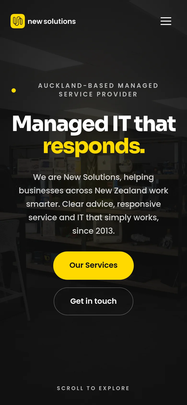 The mobile version presents a vertically stacked layout with a dark office background. The headline 'Managed IT that responds.' is centered in large white and yellow text, followed by the company description and two large, centered buttons for 'Our Services' and 'Get in touch.' The top navigation is condensed into a hamburger menu icon next to the company logo.