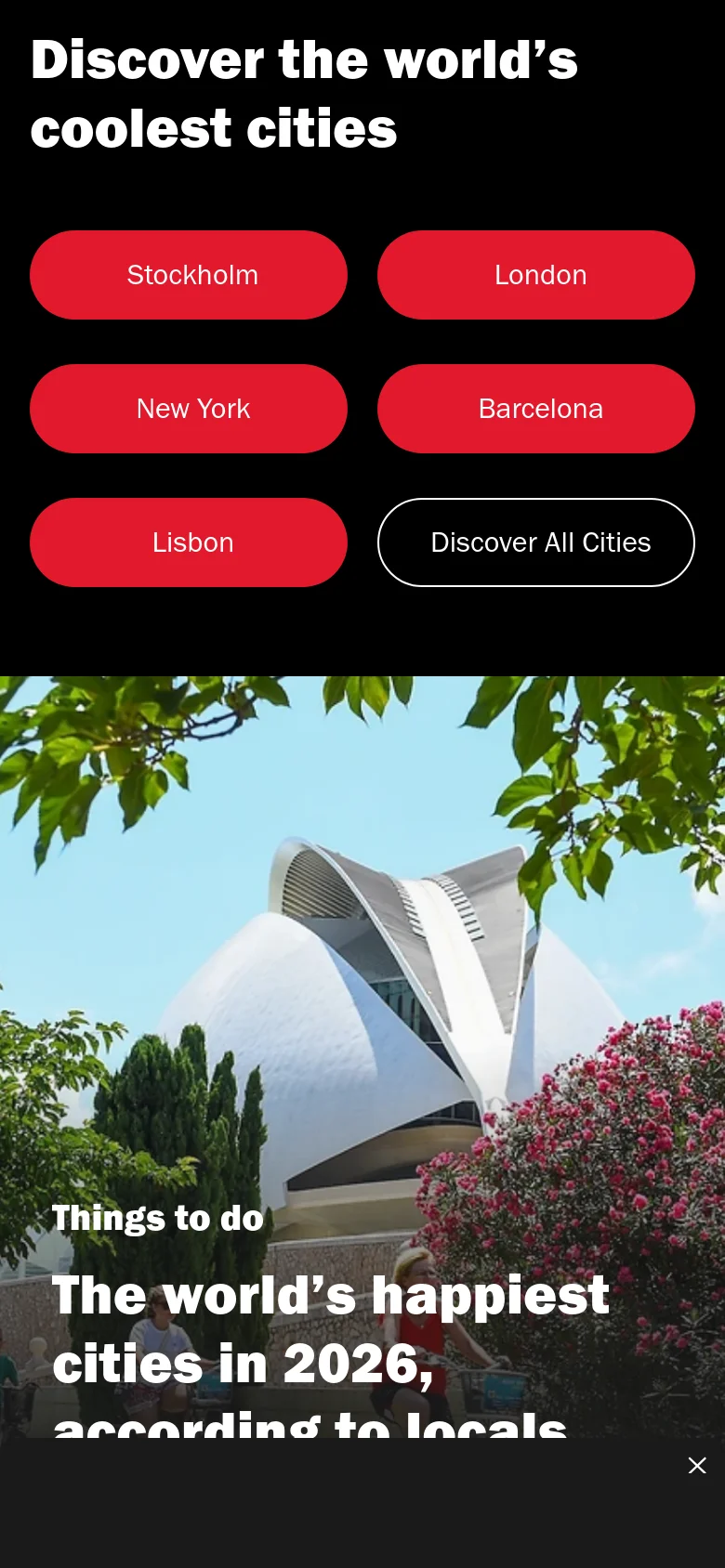 The mobile version presents a vertically stacked layout with the 'Discover the world’s coolest cities' headline followed by two columns of red city buttons and a black 'Discover All Cities' button. The hero image of the white building and pink flowers follows, with the article headline and 'Things to do' category text overlaid directly on the image.