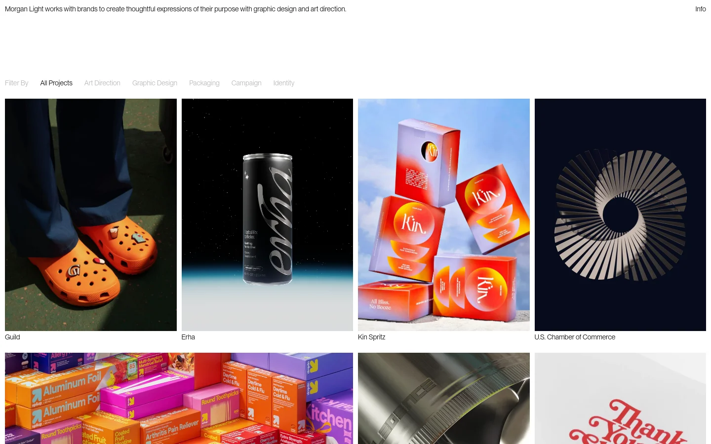 The Morgan Light homepage features a minimalist white background with a text-based header describing the brand's graphic design and art direction services. Below, a portfolio grid displays large, high-quality project images for Guild, Erha, Kin Spritz, and U.S. Chamber of Commerce, organized by filterable categories like Art Direction and Packaging.