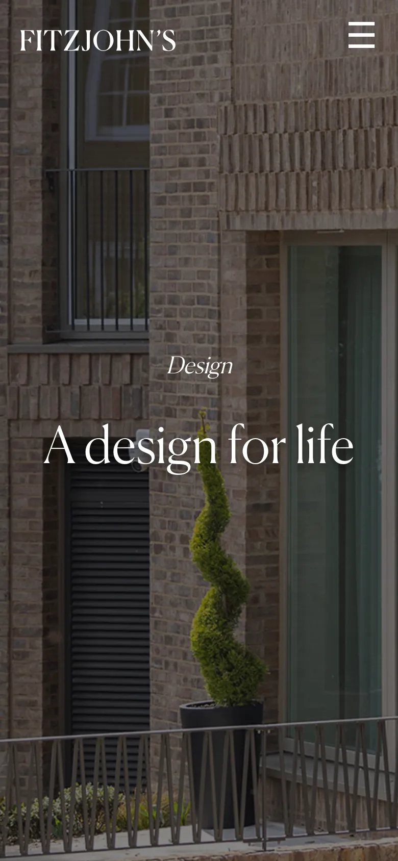 The mobile version shows the same brick building hero image but with a simplified layout. The logo is positioned at the top left, and the navigation menu is replaced by a white hamburger icon in the top right, with the 'Design' heading and 'A design for life' headline centered vertically.