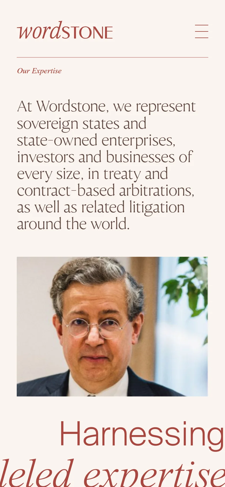 The mobile version uses a single-column vertical layout optimized for small screens. The Wordstone logo is centered at the top above a hamburger menu icon, followed by the headline and a large, full-width hero image of the man with glasses.