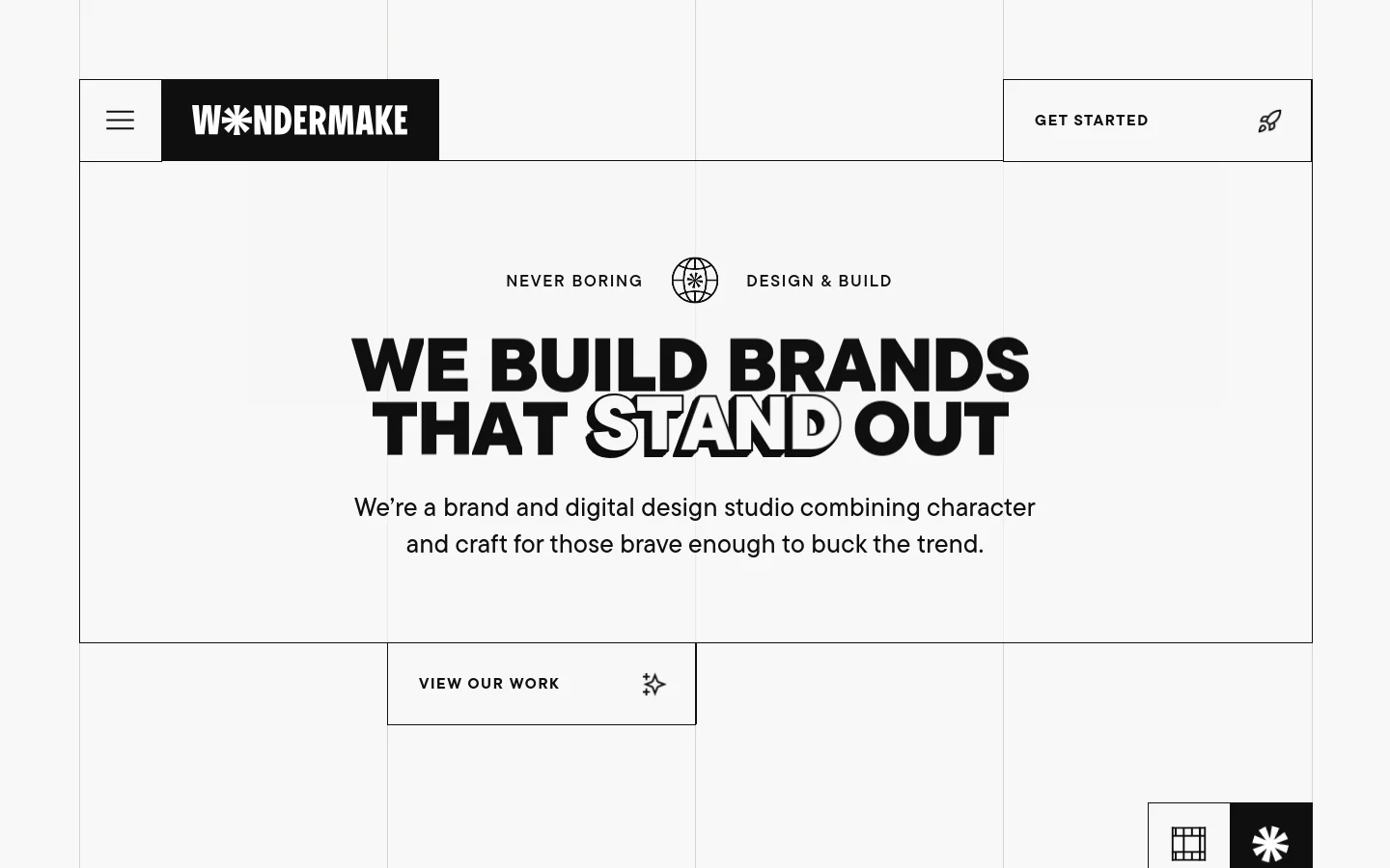The desktop homepage features a minimalist black and white design with a large hero headline reading 'WE BUILD BRANDS THAT STAND OUT'. Below the headline is a brief studio description and a prominent 'VIEW OUR WORK' call-to-action button with a small star icon. The navigation includes a hamburger menu on the left and a 'GET STARTED' link with a rocket icon on the right.