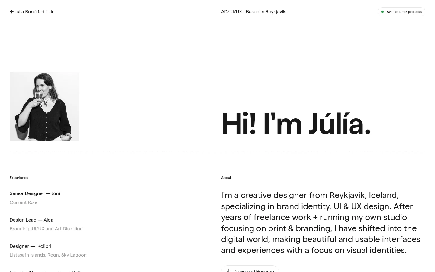 The desktop homepage for Júlía Runólfsdóttir features a minimalist white layout with a black and white portrait of Júlía on the left and a large 'Hi! I'm Júlía.' headline on the right. Below the hero section, the page uses a two-column layout to list professional experience on the left and an 'About' biography on the right. The design is clean with ample whitespace and simple black typography.