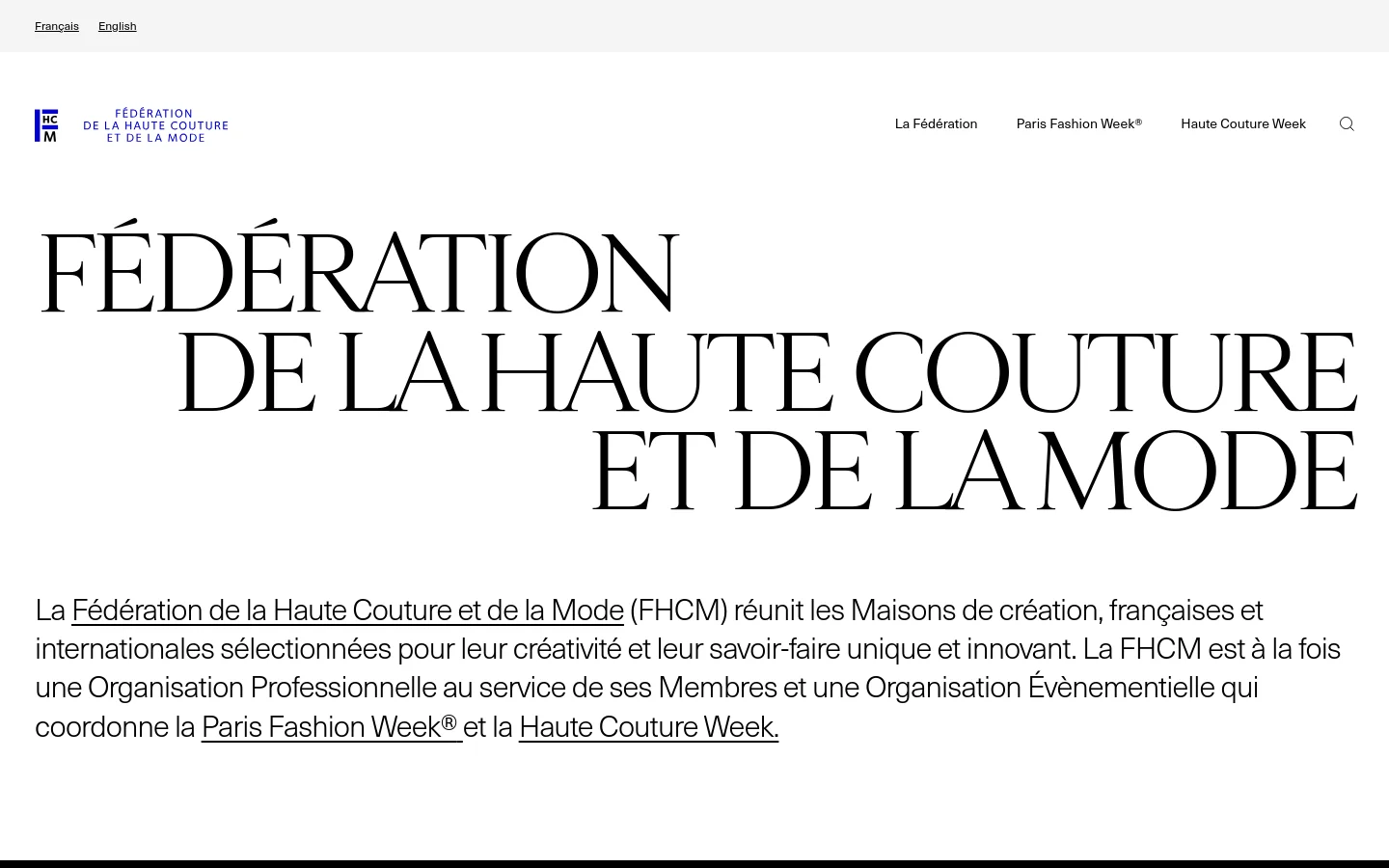 The desktop homepage features a minimalist white background with large, elegant black serif typography reading 'FÉDÉRATION DE LA HAUTE COUTURE ET DE LA MODE'. A clean navigation menu is at the top right, and a descriptive paragraph about the FHCM is positioned below the main title. The layout is spacious and high-contrast, emphasizing luxury and sophistication.