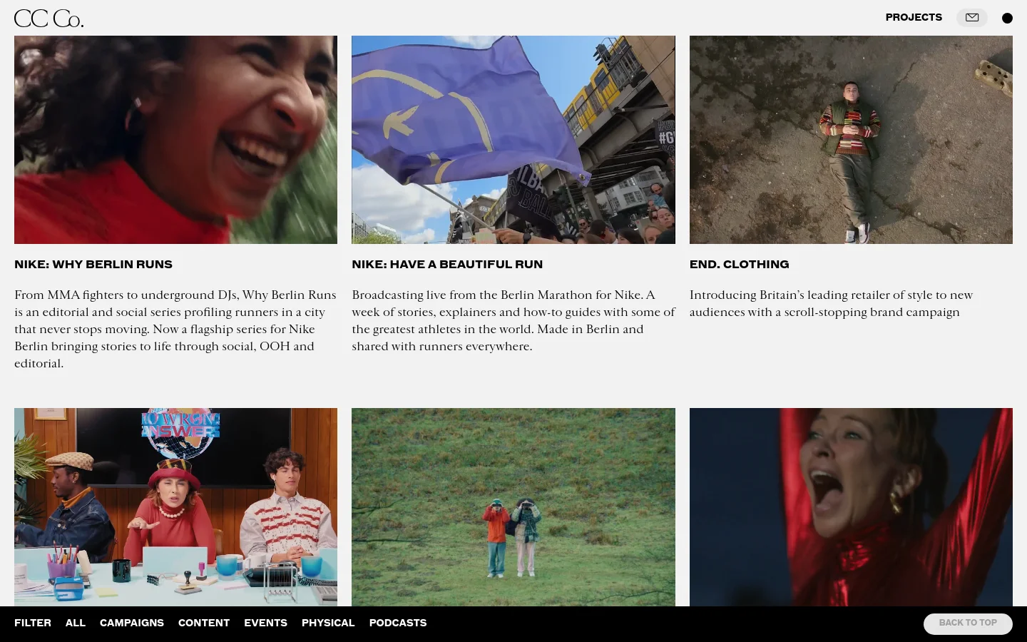 The desktop Projects page features a minimalist white background with a grid of large, cinematic rectangular images showcasing various creative works. Each image is paired with a bold black headline and a short descriptive paragraph below it. A navigation bar at the bottom includes filter options like 'ALL', 'CAMPAIGNS', and 'PODCASTS', alongside a 'BACK TO TOP' button.