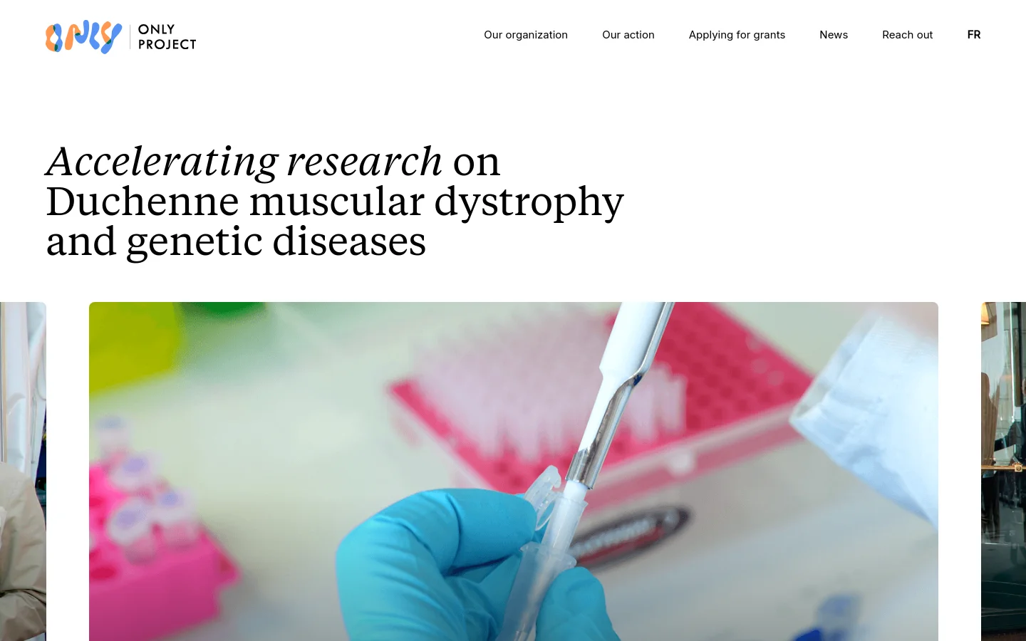 The desktop homepage features a clean white background with a large serif headline reading 'Accelerating research on Duchenne muscular dystrophy and genetic diseases.' Below the headline is a large hero image showing a close-up of a scientist in blue gloves using a pipette in a laboratory setting. The navigation menu at the top includes links for Our organization, Our action, Applying for grants, News, Reach out, and a language selector.