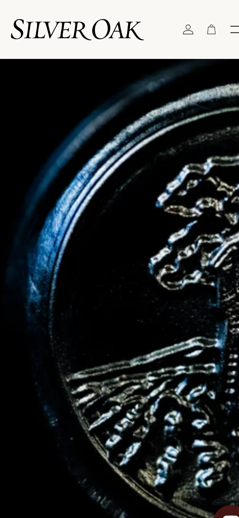The mobile version maintains the dark, dramatic hero image of the embossed oak tree seal but crops it more tightly. The header is simplified, replacing the full navigation menu with a hamburger menu icon next to the Silver Oak logo and user account icons.