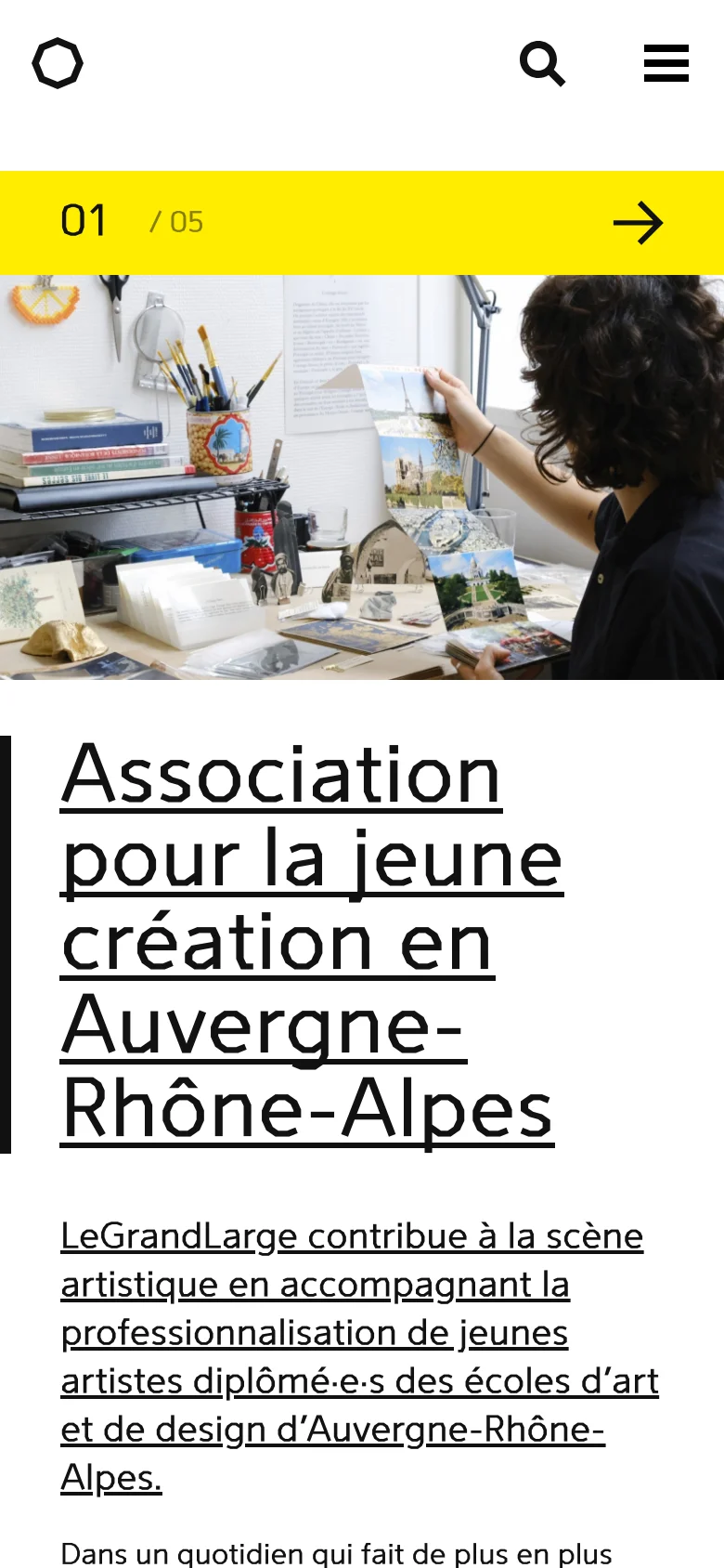 The mobile version presents a simplified vertical layout with a hamburger menu and search icon at the top. The hero section features a large, full-width image of an artist's workspace, followed by a bright yellow bar indicating the slide progress. The main heading and introductory text are stacked vertically below the image for easy scrolling.