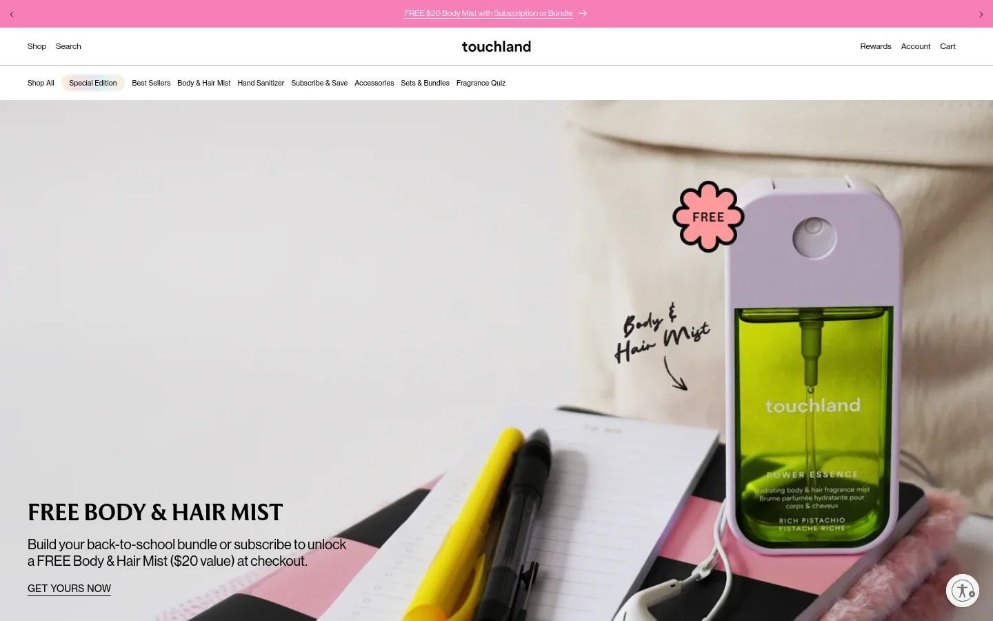 The desktop homepage features a clean, minimalist design with a large hero image of a lime-green Touchland mist sprayer next to school supplies. A promotional banner at the top offers a free body and hair mist, followed by a navigation menu with links to shop categories like Special Edition and Best Sellers. The layout uses ample white space and bold black typography against soft, lifestyle-oriented imagery.