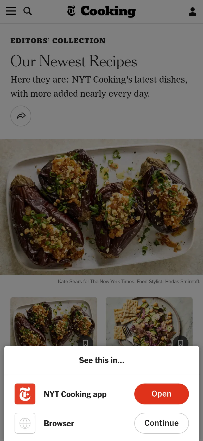 The mobile version presents a vertically stacked layout with the hero image of roasted eggplant appearing above the recipe grid. A bottom pop-up overlay invites the user to 'See this in...' the NYT Cooking app or continue in the browser. Navigation is condensed into a hamburger menu and search icon at the top.