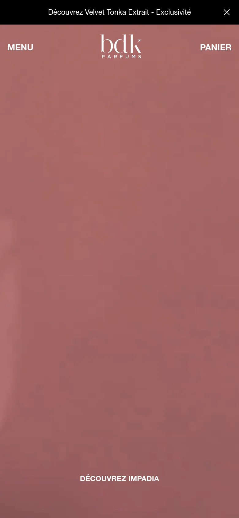 The mobile version simplifies the layout, replacing the top navigation bar with a 'MENU' text link on the left and 'PANIER' on the right, flanking the BDK Parfums logo. The hero imagery remains a full-screen, warm-toned abstract background, and the 'DÉCOUVREZ IMPADIA' call to action is positioned centrally near the bottom of the screen.