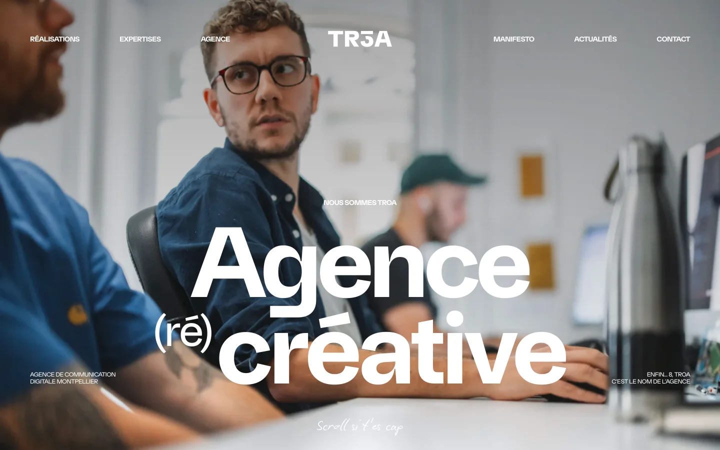 The desktop homepage features a large hero image of a creative team working in an office, overlaid with bold white typography reading 'Agence (ré) créative'. A navigation bar at the top includes links for Réalisations, Expertises, Agence, Manifesto, Actualités, and Contact, flanking a central 'TR3A' logo. The layout is clean with a minimalist aesthetic and a light gray and white color palette.