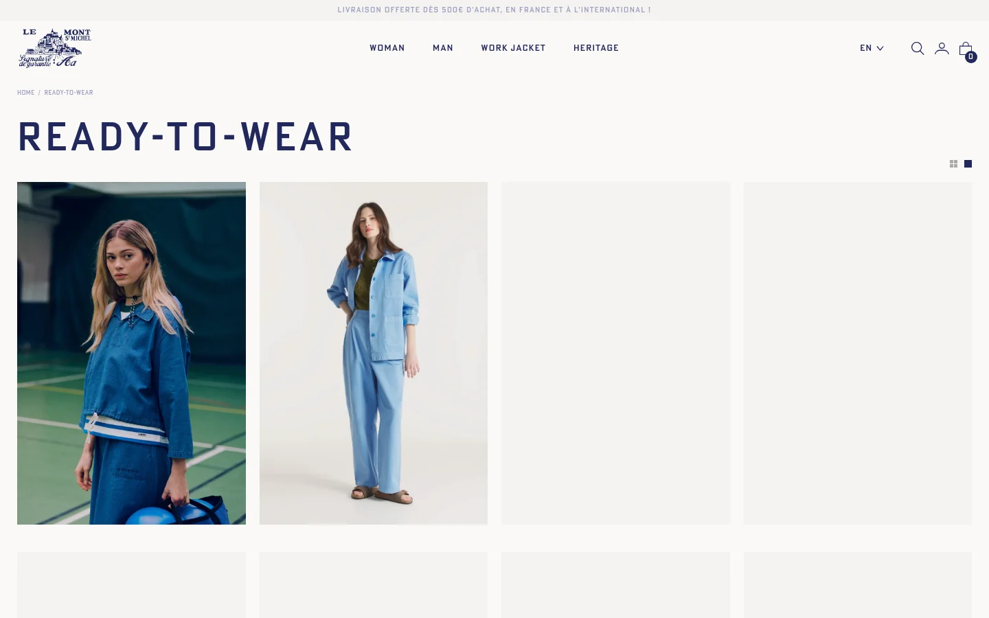 The desktop version of the Ready-to-Wear category page features a clean, minimalist layout with a white background and dark navy typography. A large 'READY-TO-WEAR' headline is positioned above a grid of high-quality fashion product images showcasing denim and work jackets. The navigation menu at the top includes links for Woman, Man, Work Jacket, and Heritage, alongside search, account, and shopping bag icons.