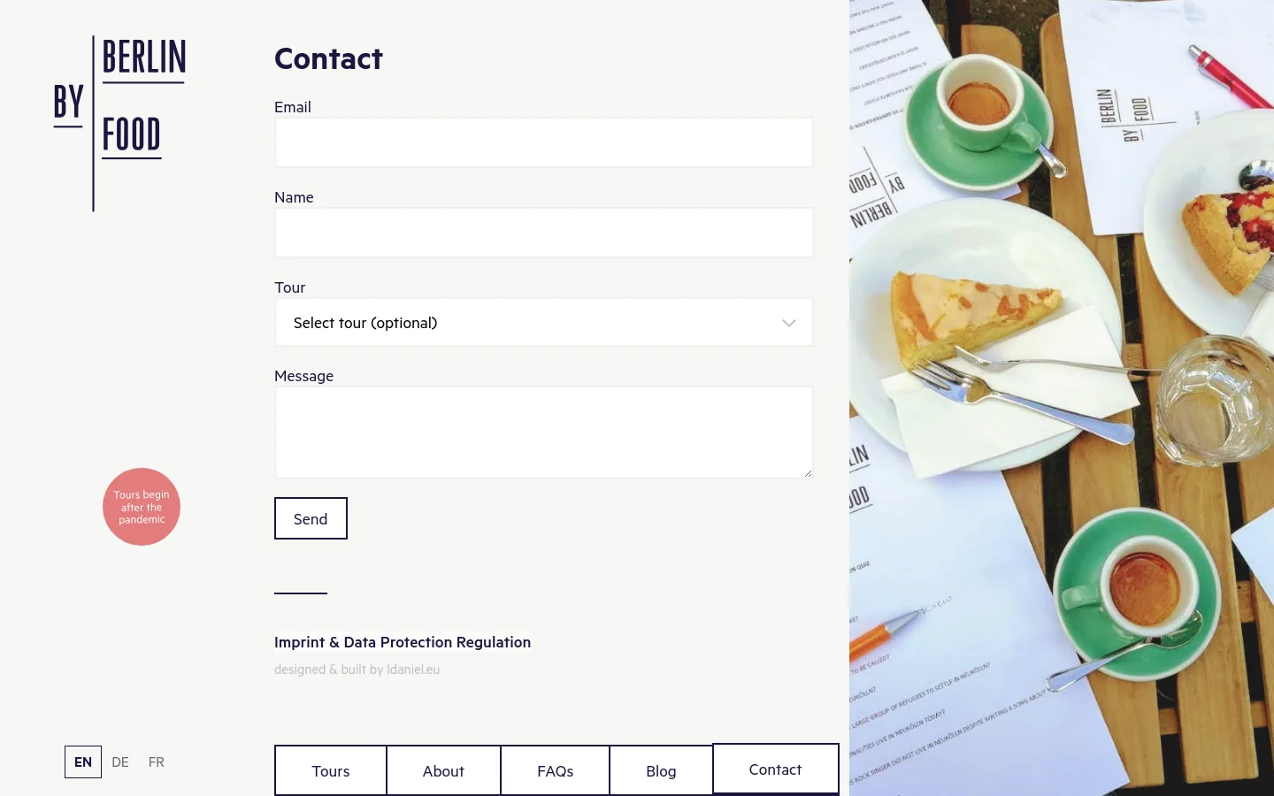The Contact page features a clean, minimalist layout with a white background and a vertical logo on the left. A contact form includes fields for Email, Name, a Tour dropdown, and a Message box, followed by a 'Send' button. The right side of the page is occupied by a large, vibrant hero image of a wooden table spread with coffee, pastries, and menus.