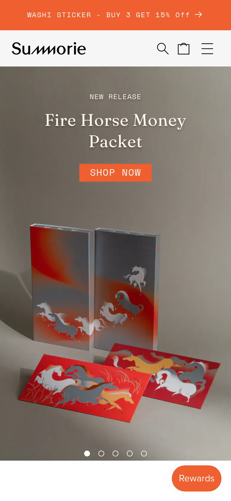 The mobile version uses a condensed layout with a hamburger menu, search icon, and shopping bag icon in the header. The hero section is vertically oriented, centering the 'Fire Horse Money Packet' headline and orange 'SHOP NOW' button above the product imagery. A floating orange 'Rewards' button is visible in the bottom right corner.