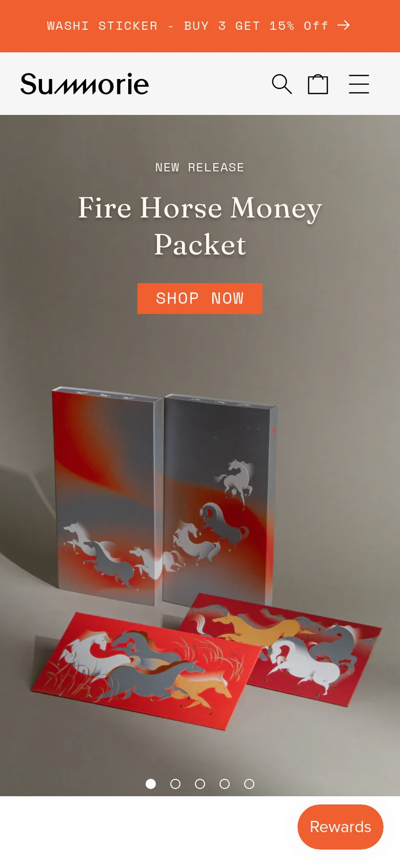 The mobile version uses a condensed layout with a hamburger menu, search icon, and shopping bag icon in the header. The hero section is vertically oriented, centering the 'Fire Horse Money Packet' headline and orange 'SHOP NOW' button above the product imagery. A floating orange 'Rewards' button is visible in the bottom right corner.