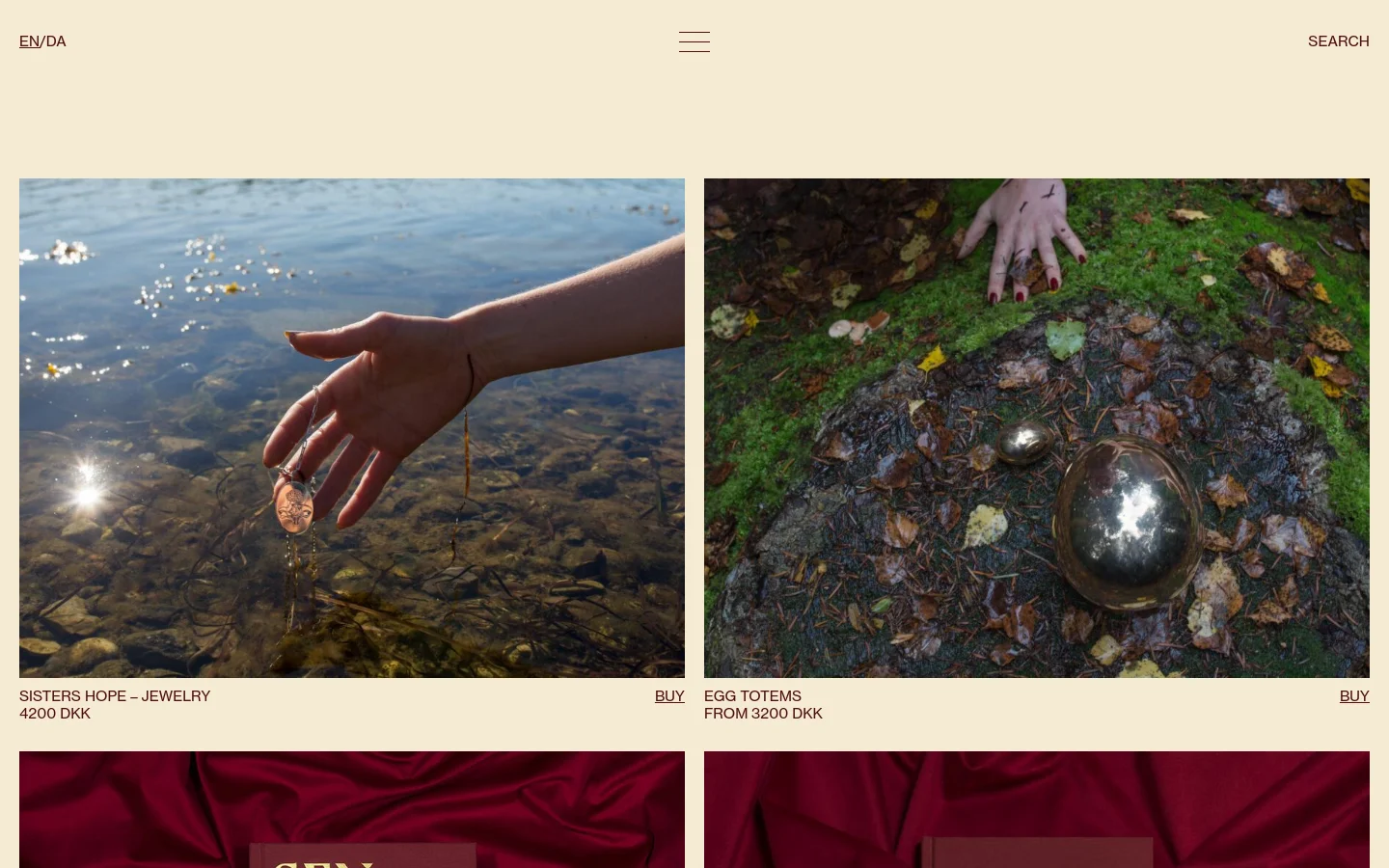 The desktop shop page features a minimalist cream background with a grid of large, high-quality product images. Each product entry includes a descriptive headline, price in DKK, and a 'BUY' call to action link. The layout is spacious, showcasing items like jewelry and totems through evocative lifestyle photography.