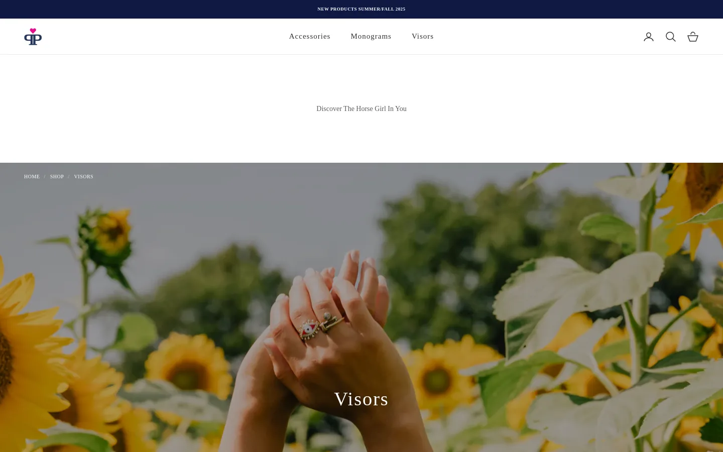 The desktop collection page for Visors features a large hero image of hands reaching toward sunflowers with the text 'Visors' overlaid. Below the hero, a product grid displays two Sun Shield Visors in pink and burgundy, each priced at $45.00, with filtering and sorting options available above the products.