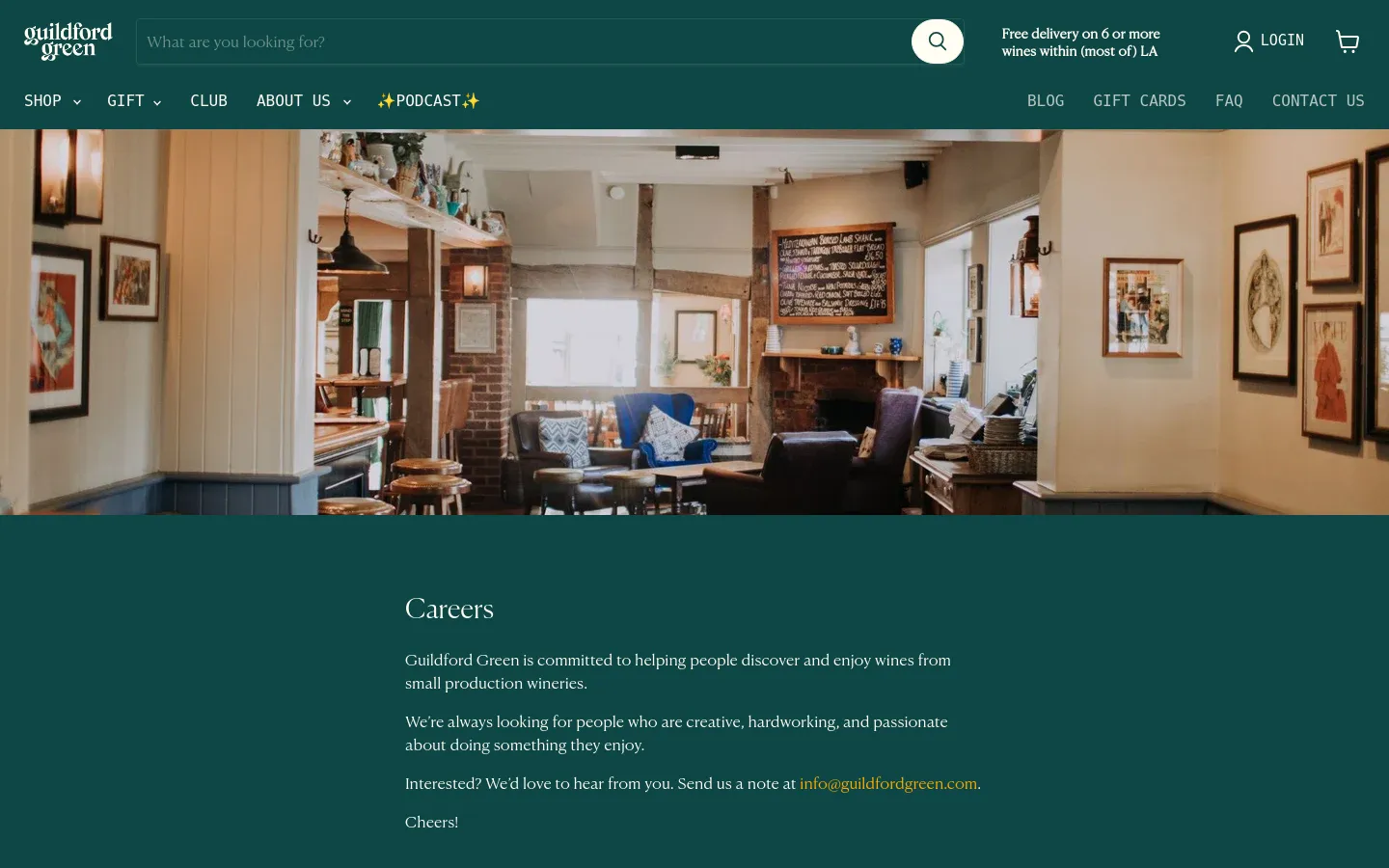 Desktop view of the Careers page featuring a wide hero image of a cozy, rustic lounge with armchairs and a fireplace. Below the image, a dark green section contains the headline 'Careers' in white serif font, followed by text inviting interested candidates to email info@guildfordgreen.com.