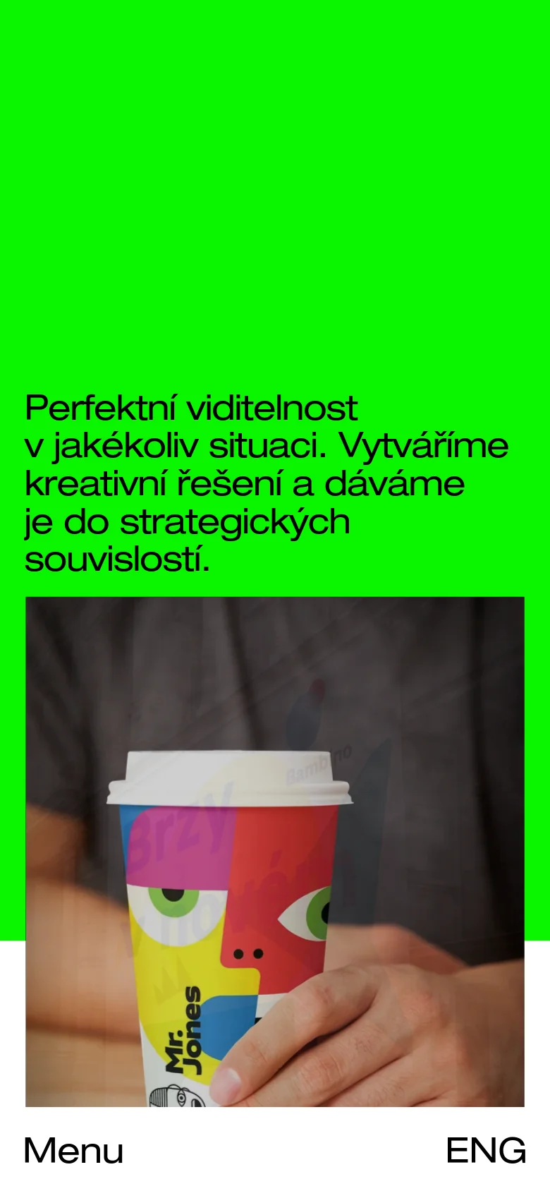 The mobile version maintains the high-contrast lime green and black color scheme but uses a vertical stack layout. The large headline is centered, followed by a single large hero image of a branded cup. The navigation is simplified into a 'Menu' label and an 'ENG' language toggle at the bottom of the screen.