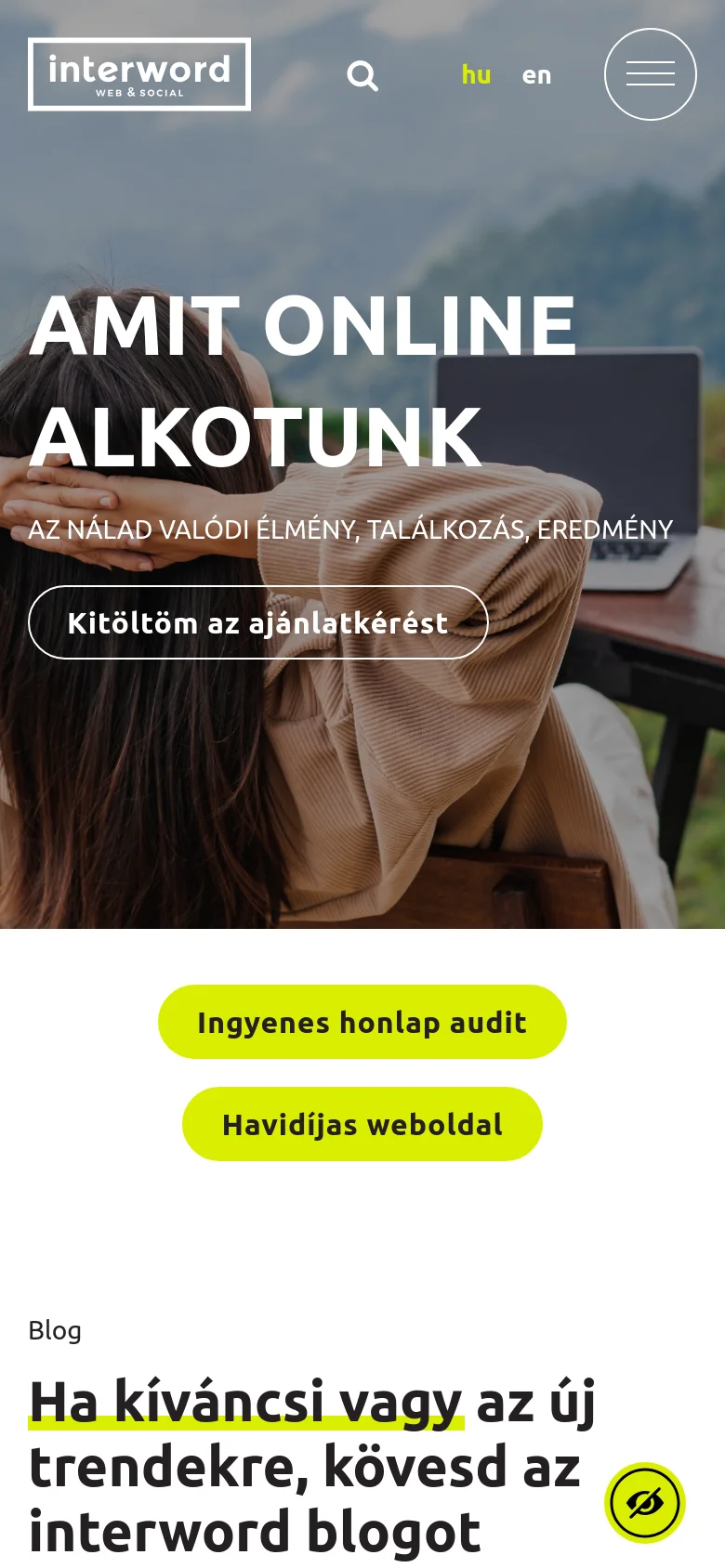 The mobile version presents a vertically stacked layout with the hero text and call-to-action button centered over the mountain landscape image. The header is simplified, showing the logo, a search icon, language options, and a large hamburger menu icon. Below the hero section, bright yellow pill-shaped buttons for 'Ingyenes honlap audit' and 'Havidíjas weboldal' are prominently displayed.