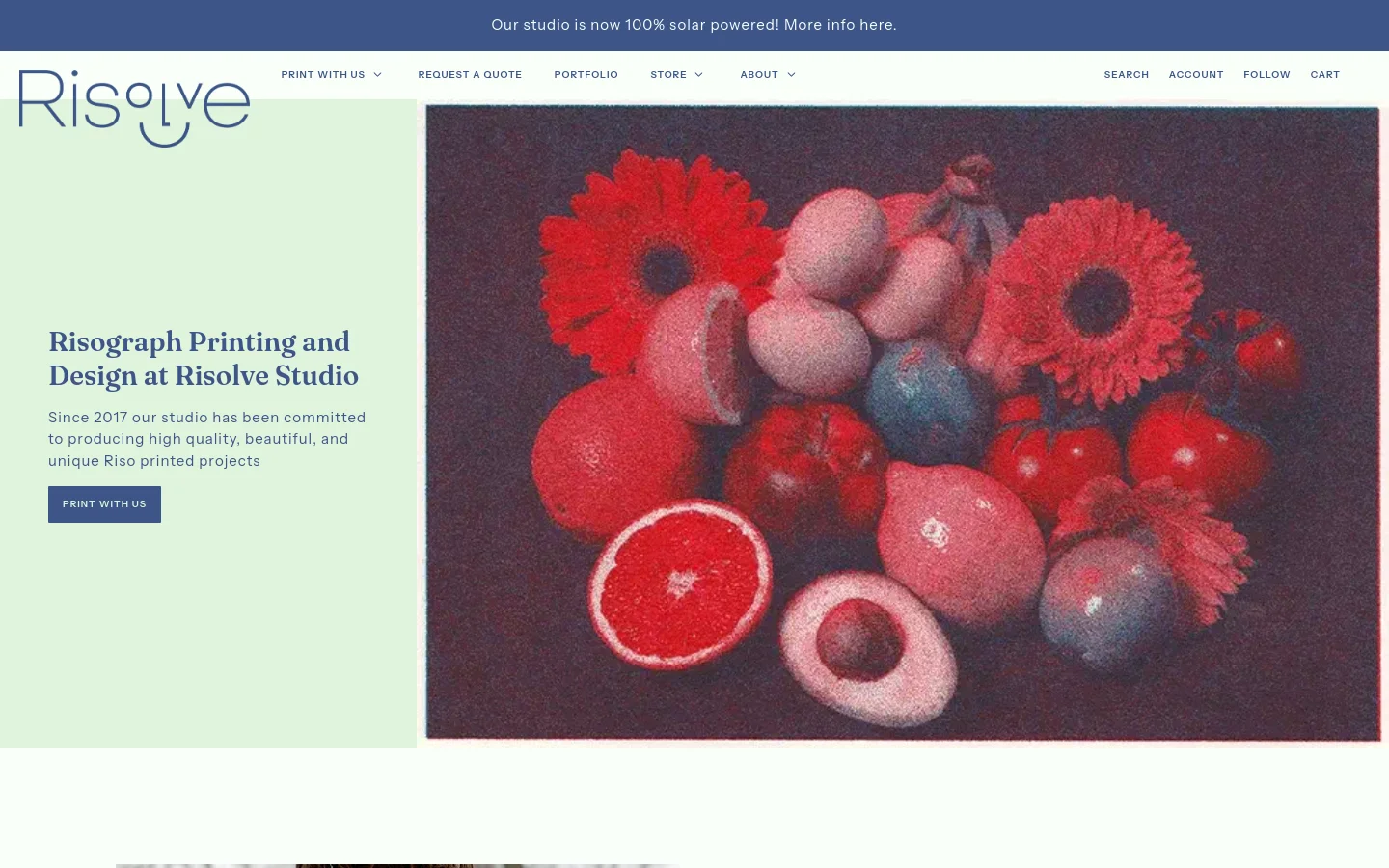 The desktop homepage features a split layout with a light mint green section on the left containing the Risolve logo, a headline about Risograph printing, and a 'Print With Us' button. The right side displays a large, textured hero image of red and pink fruit and flowers against a dark background. A dark blue announcement bar at the top notes the studio is 100% solar powered.