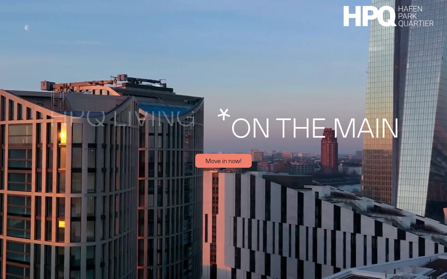 Desktop homepage for HPQ Living featuring a large hero image of modern high-rise buildings against a sunset sky. The headline 'HPQ LIVING * ON THE MAIN' is overlaid on the image next to a salmon-colored 'Move in now!' button. The layout includes a clean navigation bar with a language selector and logo at the top.