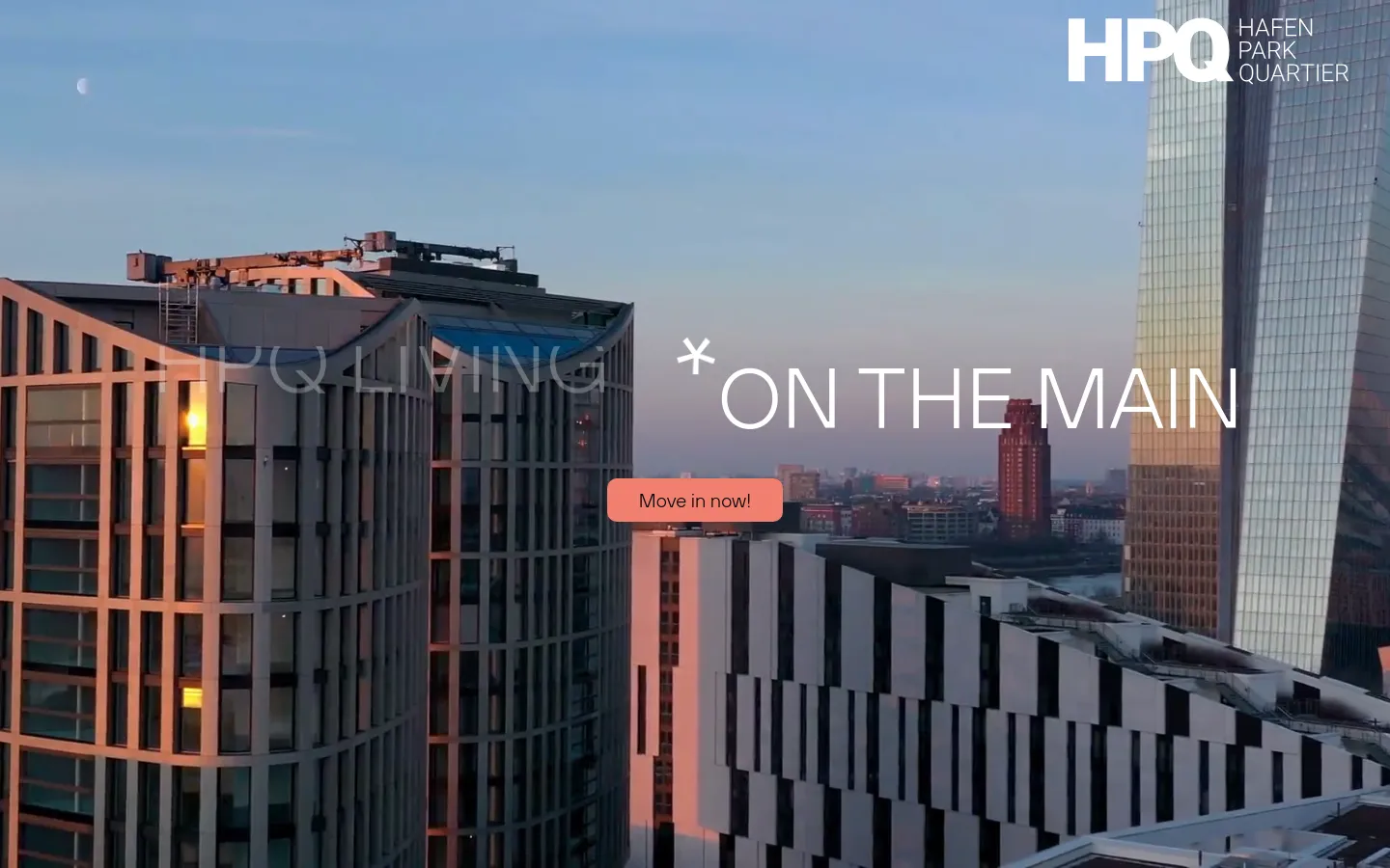 Desktop homepage for HPQ Living featuring a large hero image of modern high-rise buildings against a sunset sky. The headline 'HPQ LIVING * ON THE MAIN' is overlaid on the image next to a salmon-colored 'Move in now!' button. The layout includes a clean navigation bar with a language selector and logo at the top.