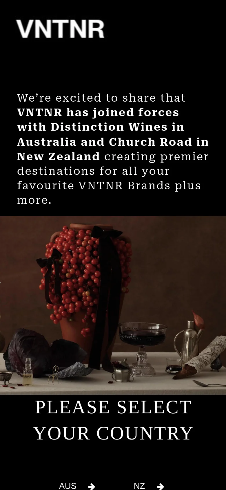 The mobile version uses a vertical layout with the announcement text positioned above a large, full-width hero image of red berries and glassware. The 'PLEASE SELECT YOUR COUNTRY' heading and the 'AUS' and 'NZ' selection links are stacked vertically at the bottom of the screen.