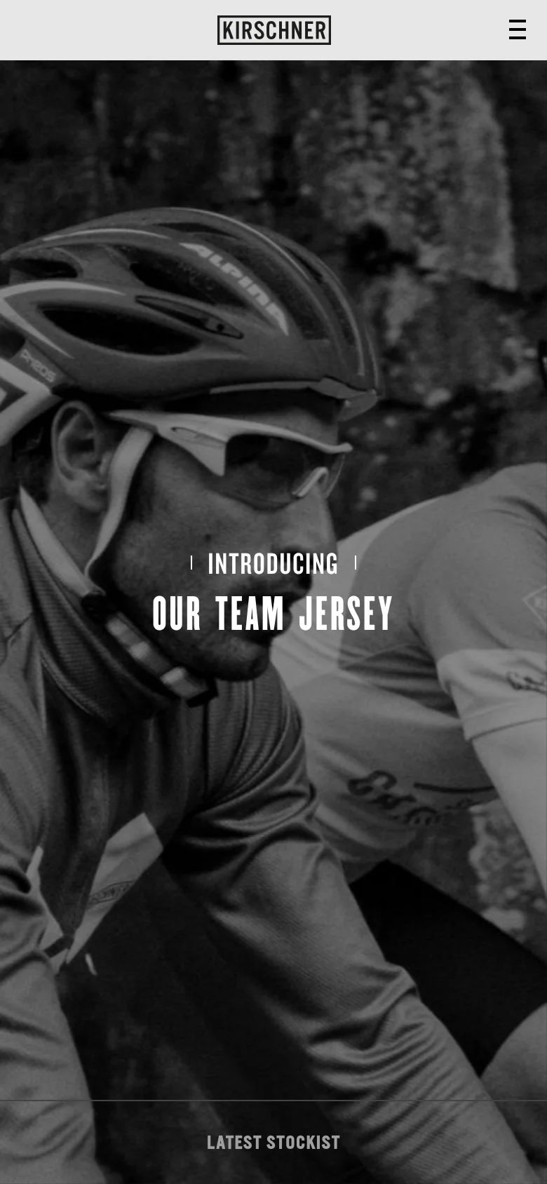 The mobile version presents a vertically oriented, full-screen black-and-white hero image of a cyclist. The navigation is condensed into a hamburger menu icon in the top right, and the 'INTRODUCING OUR TEAM JERSEY' headline is centered over the image. A single 'LATEST STOCKIST' button is visible at the bottom of the screen.