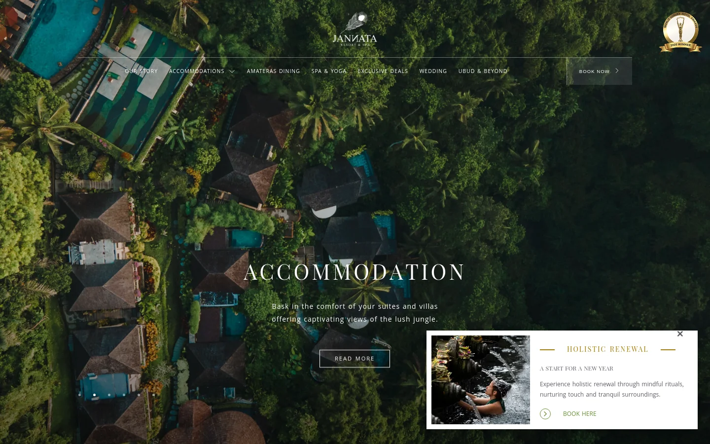 The desktop homepage features a full-screen aerial hero image of a lush jungle resort with villas and pools. A navigation menu sits at the top with links like 'Our Story' and 'Accommodations,' alongside a 'Book Now' button. A large central headline reads 'ACCOMMODATION' with a 'Read More' call to action, and a small pop-up in the corner promotes 'Holistic Renewal' with a photo of a woman at a water fountain.