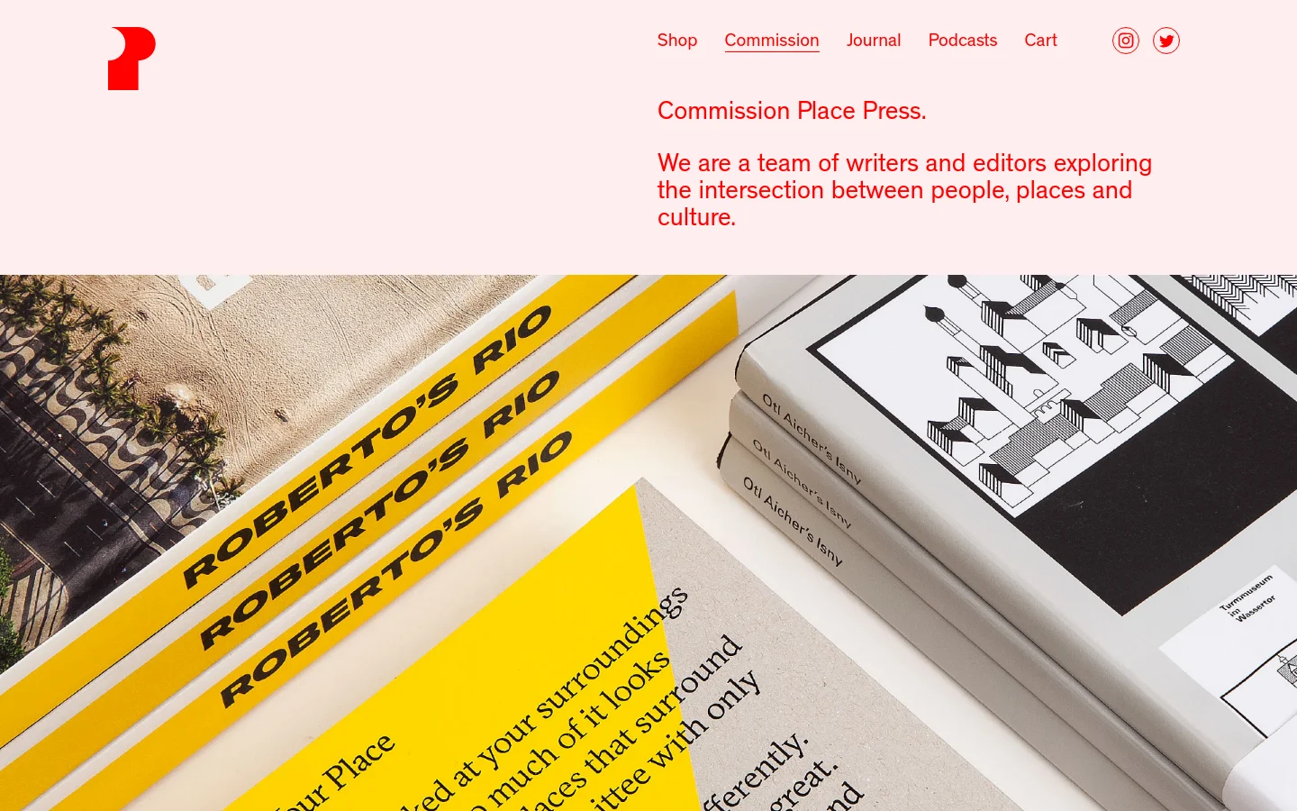 The desktop page features a minimalist design with a light pink background and red accents. A large hero image shows a close-up, angled view of several books with bold typography like 'ROBERTO'S RIO' on yellow and white covers. The layout includes a top navigation menu with links for Shop, Commission, Journal, Podcasts, and Cart, alongside social media icons.