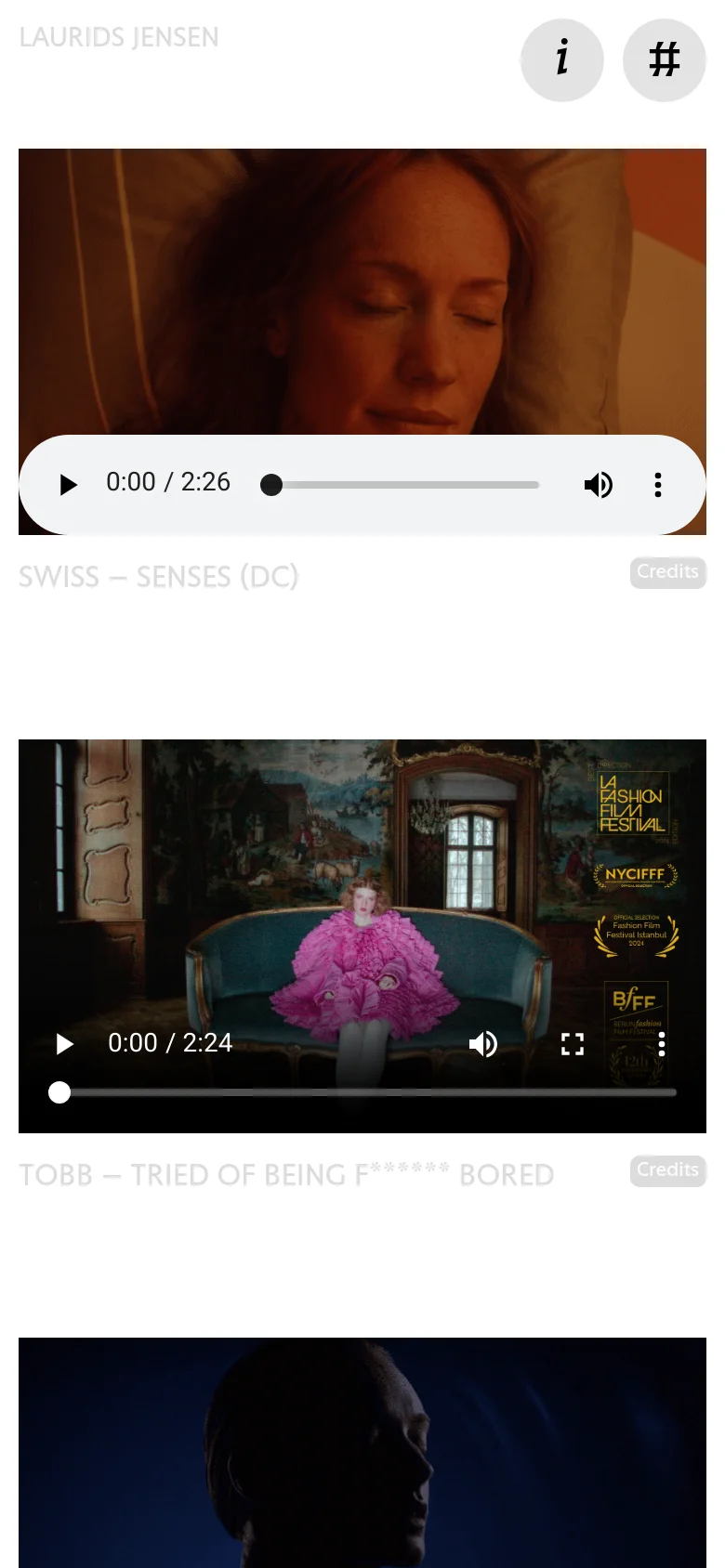 The mobile version maintains the minimalist white header but scales the video player to fit the narrower screen width. The navigation links and title are stacked or condensed, and the video playback controls are positioned at the bottom of the video frame. The overall dark, cinematic aesthetic remains consistent with the desktop view.