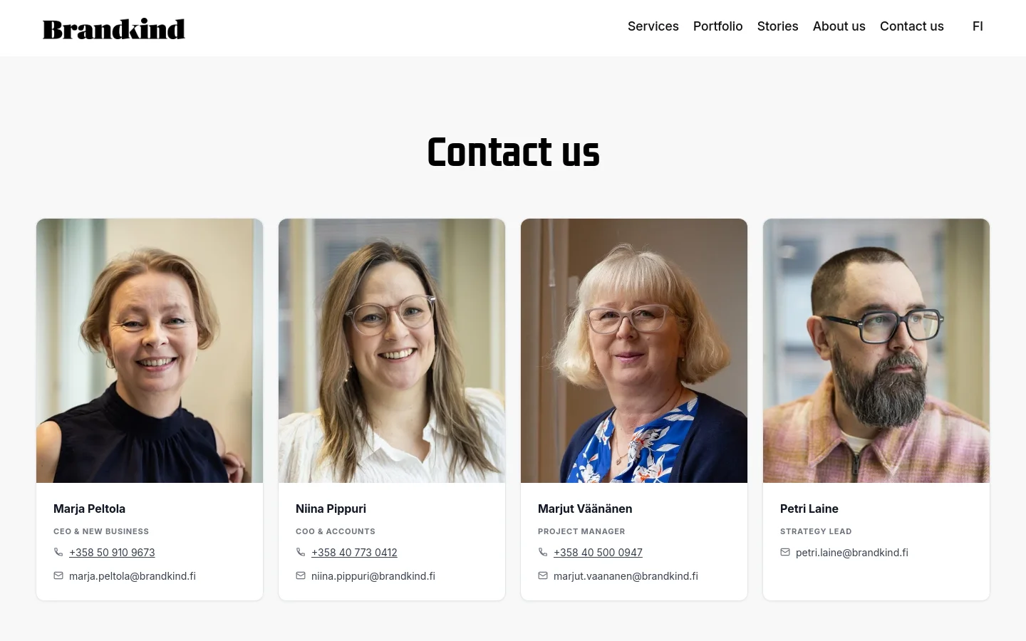 The desktop Contact Us page features a clean white background with a large, bold black headline. Below the headline, four team member profiles are arranged in a horizontal row, each consisting of a portrait photo, name, job title, phone number, and email address. The navigation menu is located at the top right, featuring links like Services, Portfolio, and About us.
