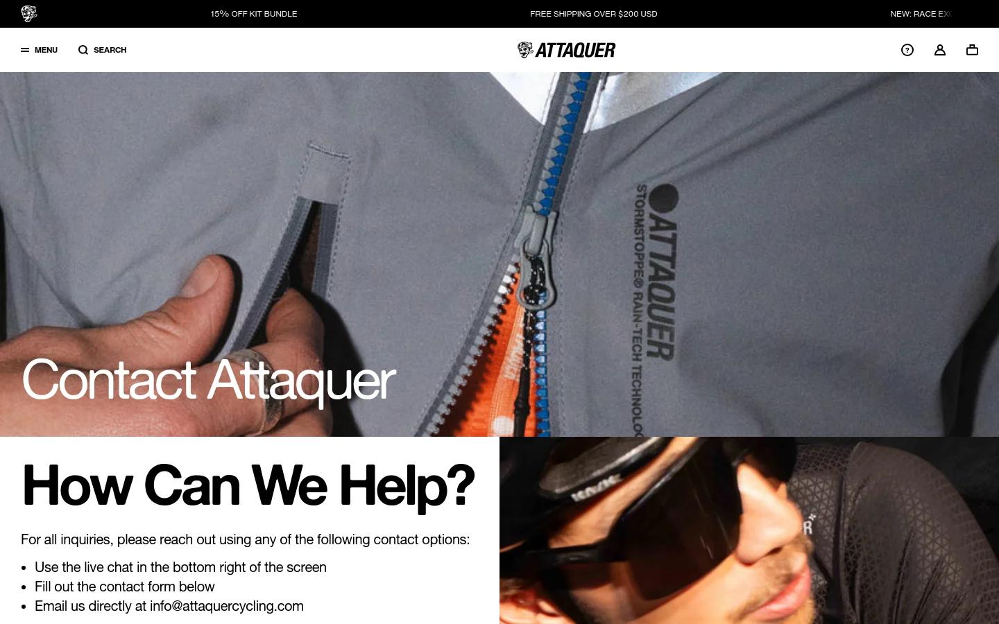 The desktop page features a large hero image of a cyclist's grey technical jacket with a blue zipper, overlaid with the white headline 'Contact Attaquer'. Below, the heading 'How Can We Help?' introduces contact options including live chat, a contact form, and an email address, set against a clean white background with black text.