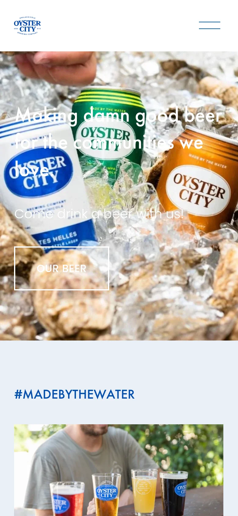 The mobile version simplifies the layout, replacing the top navigation bar with a hamburger menu icon next to the company logo. The hero section remains prominent, featuring the same ice and oyster shell imagery with the central headline and 'OUR BEER' button stacked vertically for easier tapping on a smaller screen.