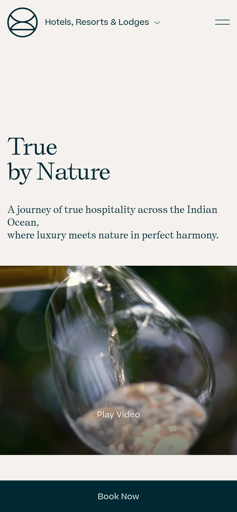 The mobile version presents a vertically stacked layout, beginning with a large hero image of a person in water with a 'Play Video' overlay. The headline 'True by Nature' and its subtext are positioned prominently above the image, and a full-width dark teal 'Book Now' button is anchored at the bottom of the screen for easy access.