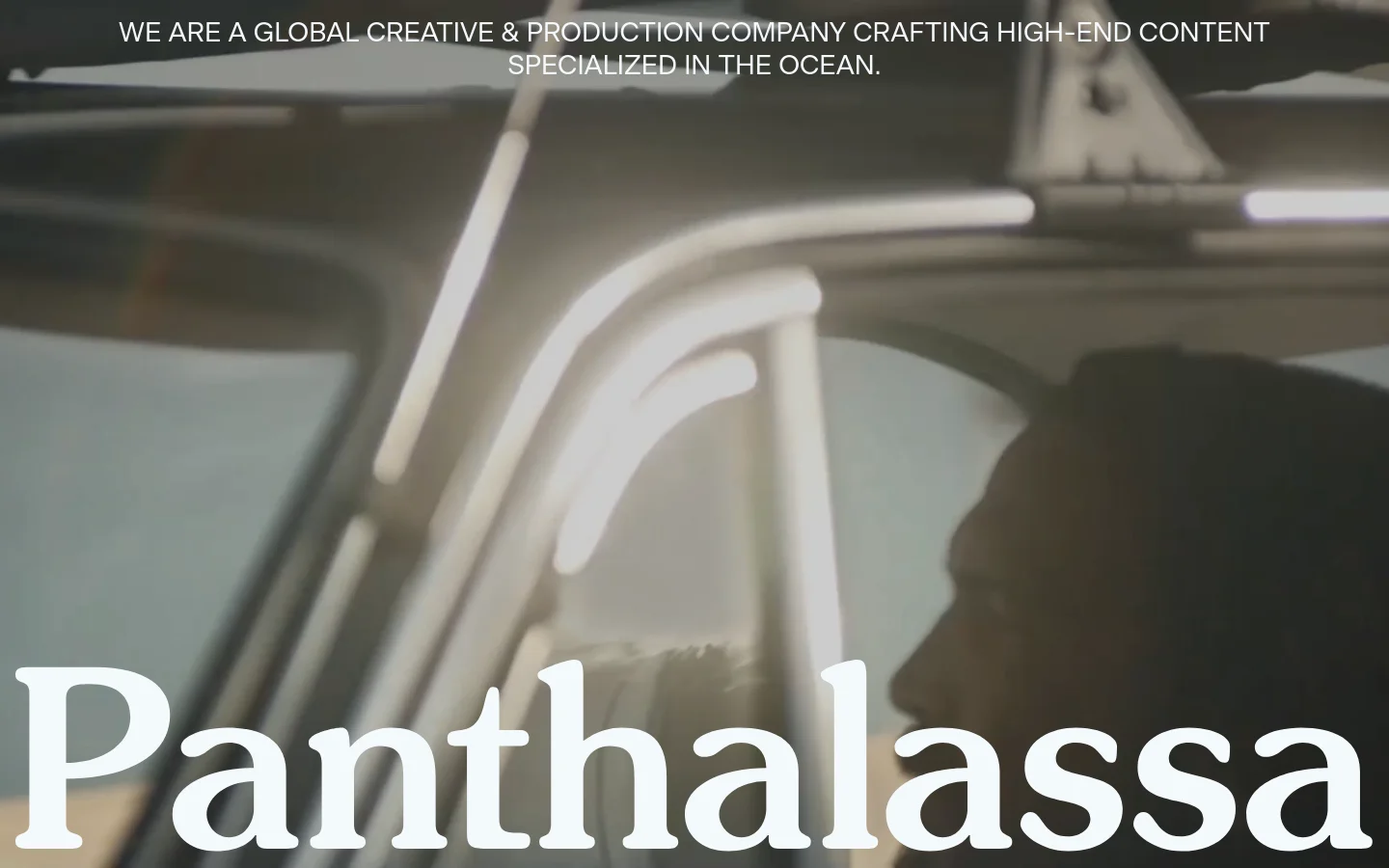 The desktop homepage features a large cinematic video background of ocean-related imagery with the white text 'Panthalassa' and a mission statement overlay. Below the hero section, a vertical scroll reveals large, high-quality project tiles for films like 'Ghost Net Zero' and 'Into the North,' each accompanied by descriptive text and video playback controls.
